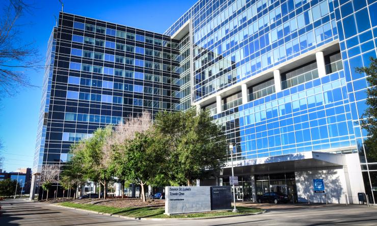 Baylor St. Luke's Tower One, a large windowed building with a blue sky behind it.