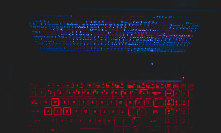 Image of a glowing computer screen and a glowing keyboard