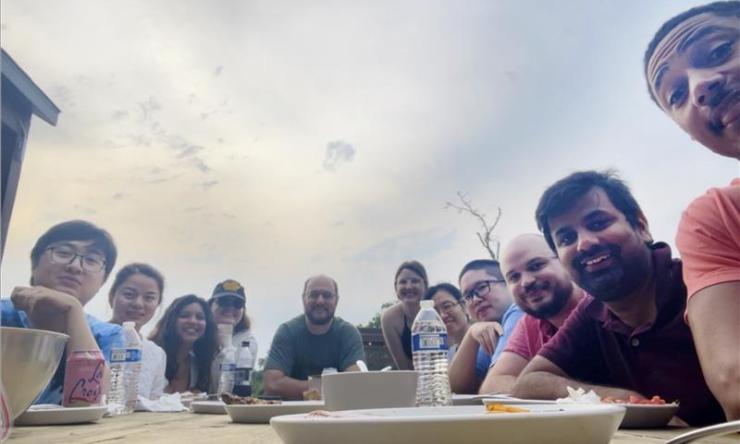 group of people sitting at a table outdoors