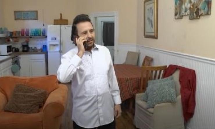 man talking on the phone in a living room