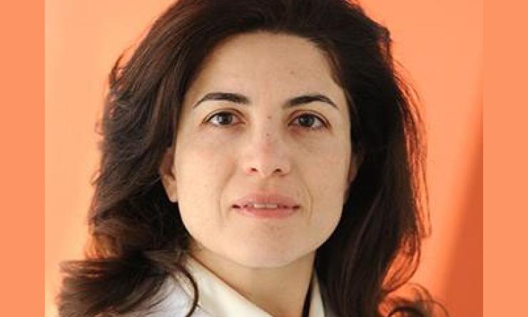 woman standing in front of orange background