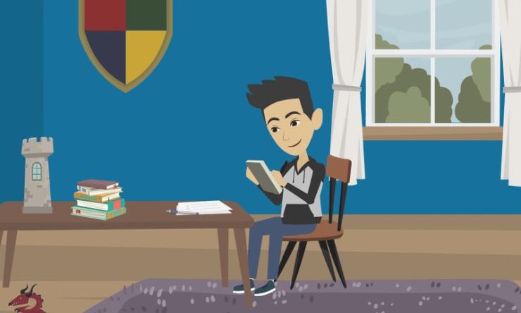 a boy sitting at a desk looking at a book