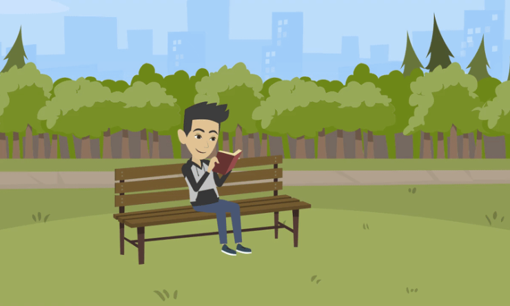 a guy sitting on a park bench reading a book