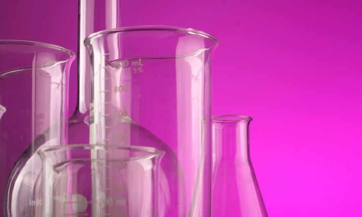 Photo of test tubes with a pink background