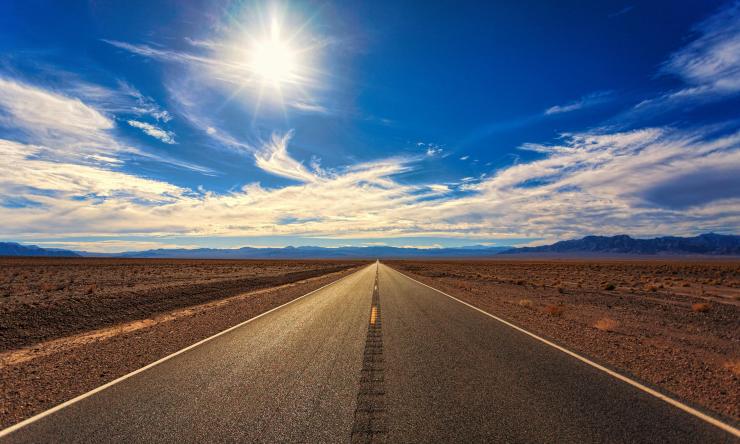 Photo of an empty road to represent a road trip and traveling