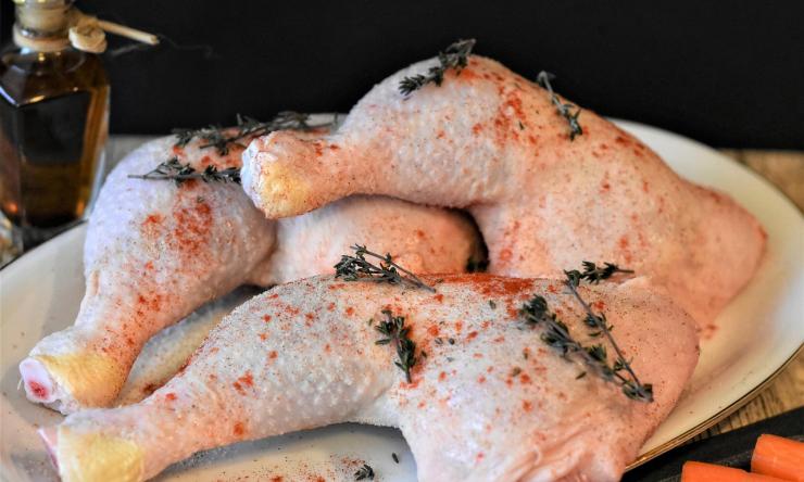 A photo of raw chicken on a plate ready to be cooked