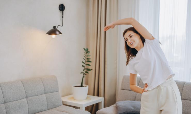woman stretching in living room