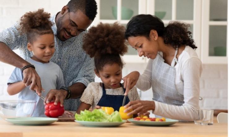 family preparing a meal together in a kitchen