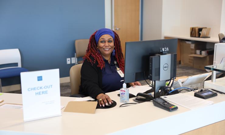 Woman sitting at computer desk in clinical area