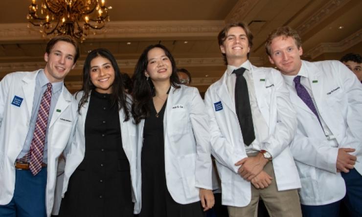 Photo of students wearing their white coats