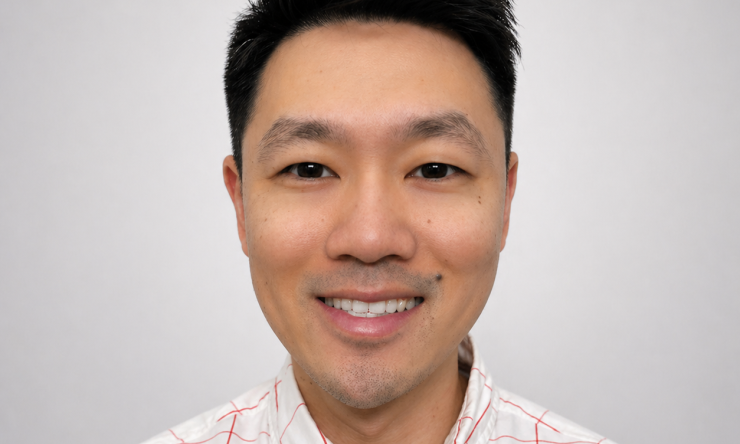man with dark hair smiling