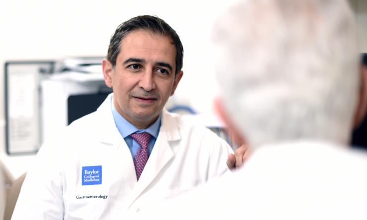 Dr. Hashim El-Serag speaking with colleague