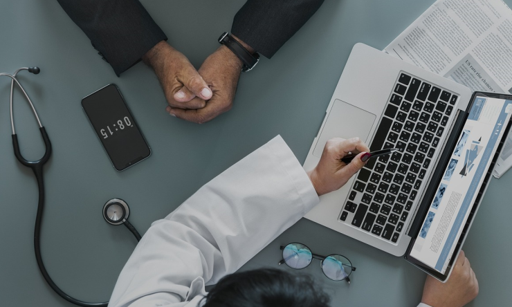 A doctor and patient in discussion during an appointment. 
