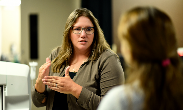 Dr. Mary Dickinson talks with a colleague in her research lab.