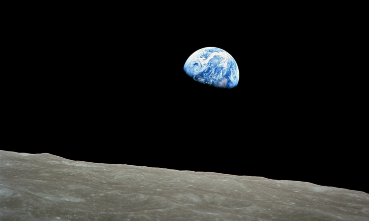 The famous Earthrise photograph from Apollo 8. The Earth is partially seen from the surface of the moon.