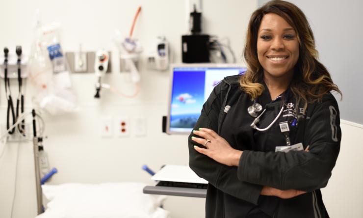 A female doctor in a patient examination room.
