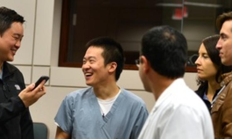 A small group of pulmonary fellows smiling and talking with one another